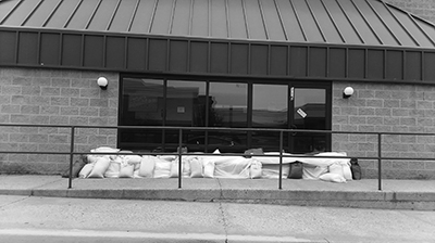 Sandbags protect a movie theater entrance from ensuing floodwaters