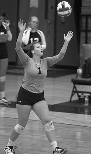 Libero Maddie Scalissi of the Madison College volleyball team setting a play.