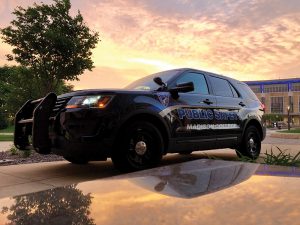 The sun rise brightens the skies behind a Madison College Public Safety patrol car during a recent morning.