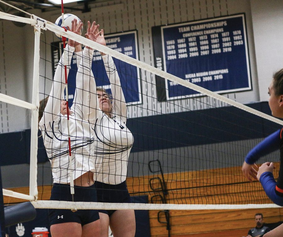 Two Madison College volleyball players attempt to block a shot