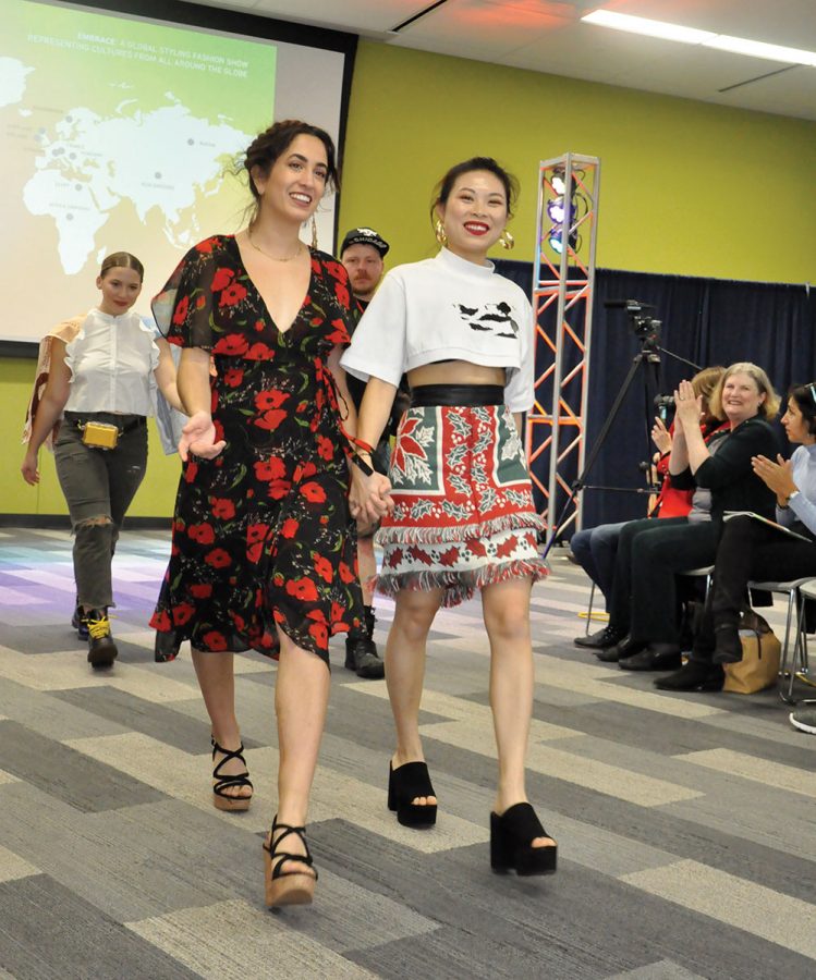 Madison Annen, left, and XinXin Nong lead the way down the walkway at the end of the “Embrace Fashion Show” on Nov. 16 at Madison College’s Truax Campus.