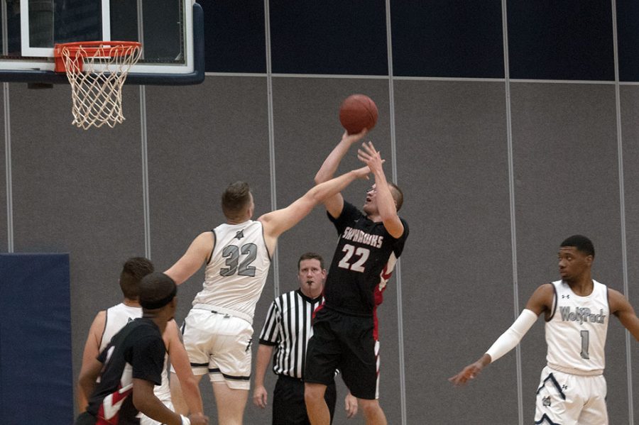 Madison College’s Adam Anhold (32) tries to block the shot of a Sauk Valley Community College opponent during a men’s basketball game on Nov. 14.