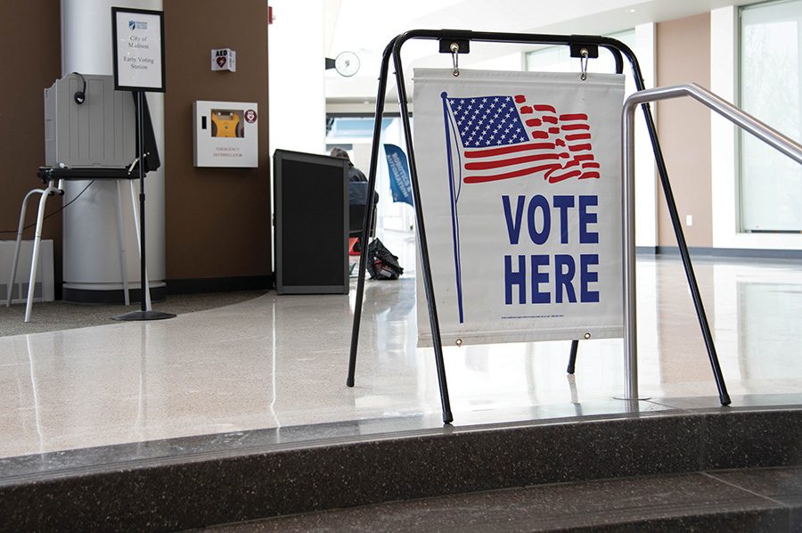 A sign directs students and visitors to the new early voting location in the Madison College Truax Campus Gateway