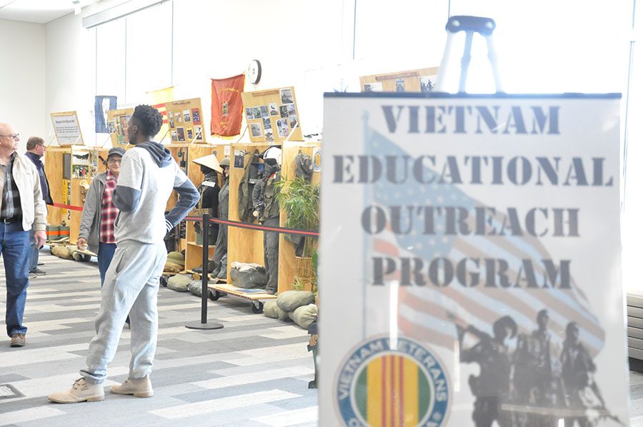 Students visit with Vietnam War veterans and look at the displays set up at the Truax campus on March 29