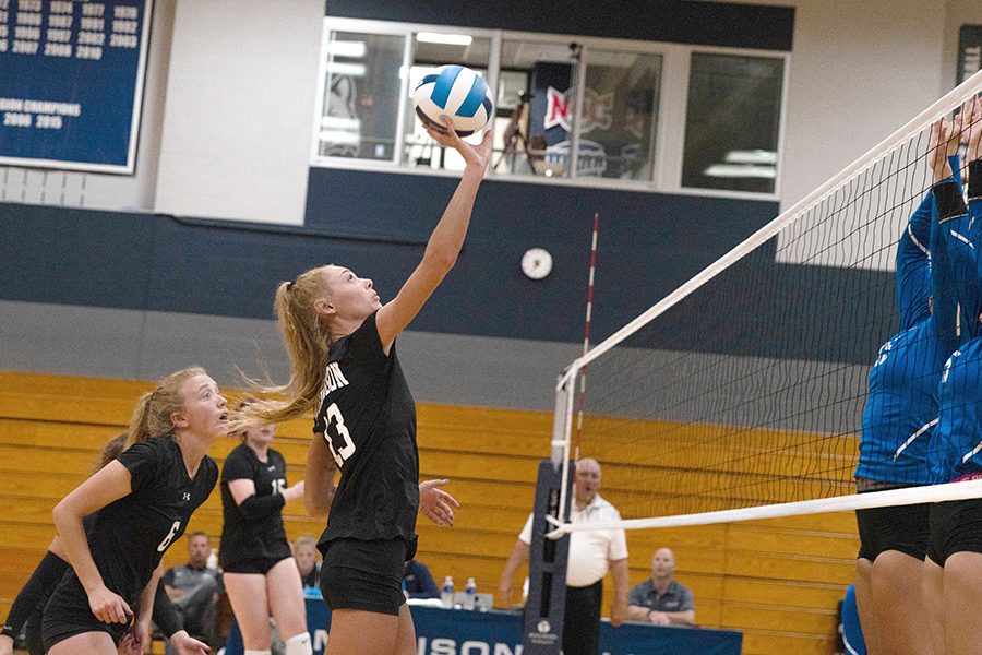 Madison College middle blocker Sidni Walgurski (13) attempts to place a shot past a pair of blockers during her teams match against Elgin Community College on Aug. 23.