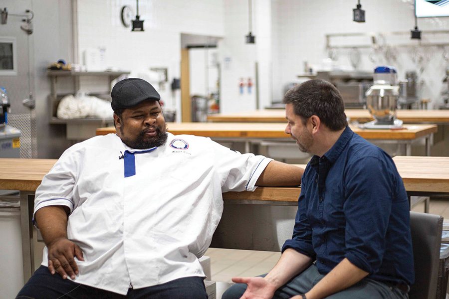 Chef Michael Twitty visists with host Kyle Cherek during the Chef Series event on Oct. 23.