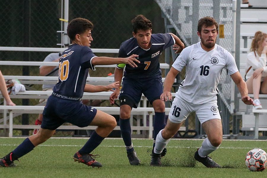 Madison College defender Cole Kleiboer (16) takes the ball away from a pair of Rock Valley College players during his teams 1-0 win on Sept. 18