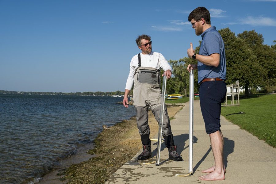 Britton Downing, left, meets with Luke Wynn of the Nearshore Water Quality Monitoring program at James Madison Park.