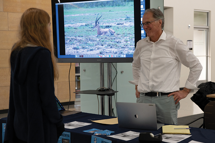 Journalism instructor Larry Hansen visits with students about the planned study abroad trip to Kenya at a promotional table in the Truax Cafeteria in December.