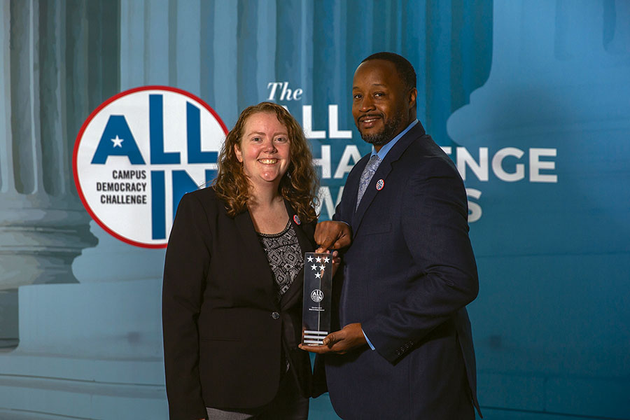 Senate advisor Ellie Rome, left, and Dr. Howard Spearman, Vice President of Student Affairs, accept an award on behalf of Madison College from the All In Campus Democraty Challenge.