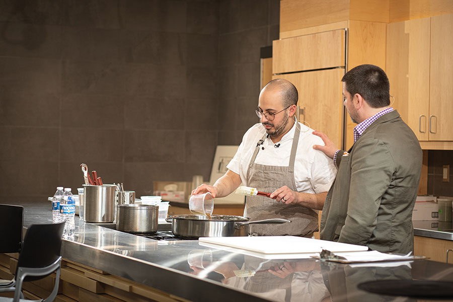 Chef Zach Engel, left, visits with host Kyle Cherek during the Feb. 26 Chef Series presentation at Madison College’s Truax Campus.