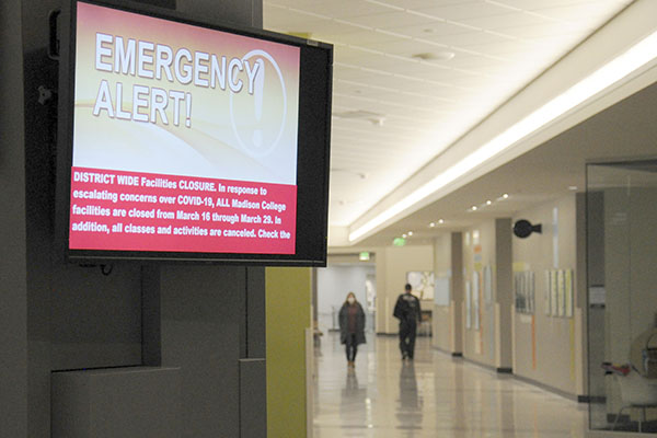 A WolfPack Alert notice on a video monitor at the Truax campus informs people of adjustments made to the Madison College schedule due to the corona virus outbreak.