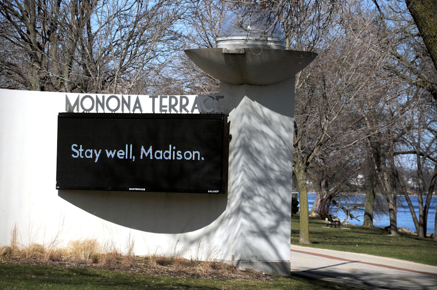 A sign on Monona Terrace offers encouragement to drivers and pedestrians to stay healthy