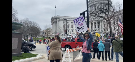 Protestors march outside the State Capitol at the end of April opposing the extension of the “safer-at-home” order.
