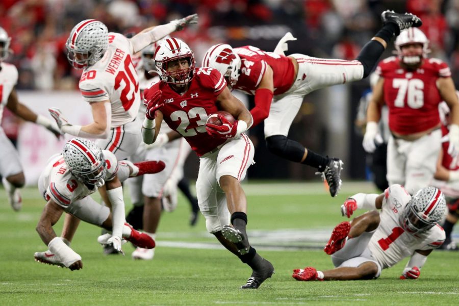 Jonathan Taylor #23 of the Wisconsin Badgers runs for a touchdown in the Big Ten Championship game against the Ohio State Buckeyes at Lucas Oil Stadium on Dec. 7, 2019, in Indianapolis, Ind.