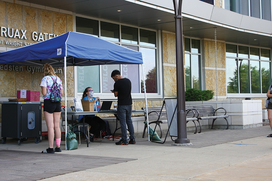 Student Program Advisor Ellie Rome helps students check into the Truax building.