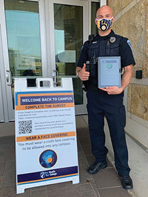 Officer Nic Tatro with a completed health survey.