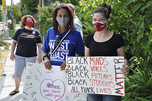 Protester hold signs supporting Althea Bernstein and the Black Lives Matter Movement