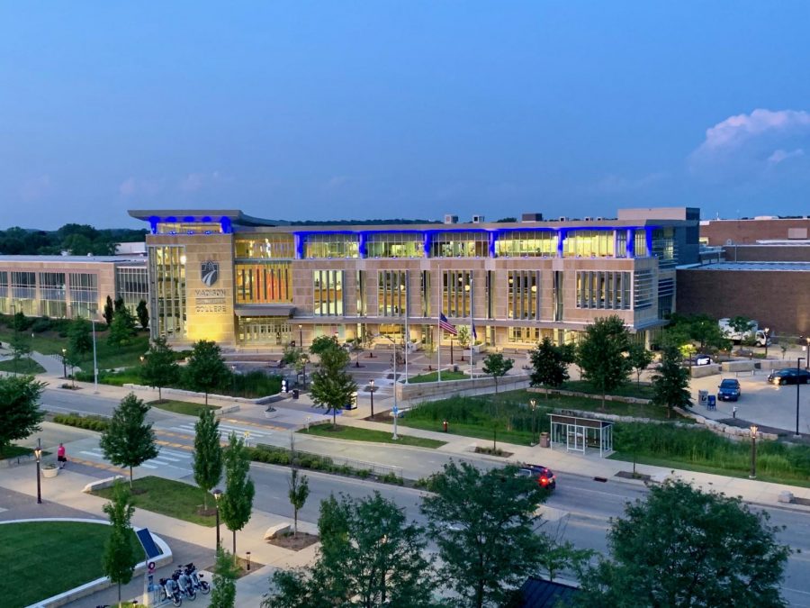 A view of the Madison College Truax Campus from the Health Education Building at dusk, shows the exterior lights coming on.