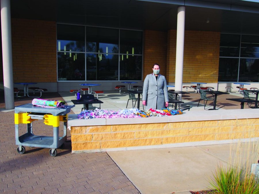 Volunteer Center advisor Brianna Stapleton-Welch stands with the dropped off cat beds outside the Truax Campus.