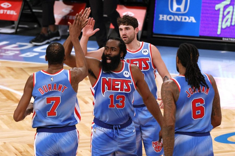The Brooklyn Nets’ Kevin Durant (7), James Harden (13), Joe Harris (12), and DeAndre Jordan (6) high-five during the first half against the Orlando Magic at Barclays Center in New York on Jan. 16.