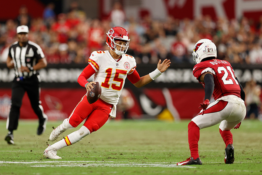 Kansas City Chiefs quarterback Patrick Mahomes (15) of the looks to pass around Arizona Cardinals cornerback Malcolm Butler (21) during the first half of a preseason game on August 20, 2021, in Glendale, Arizona. 
