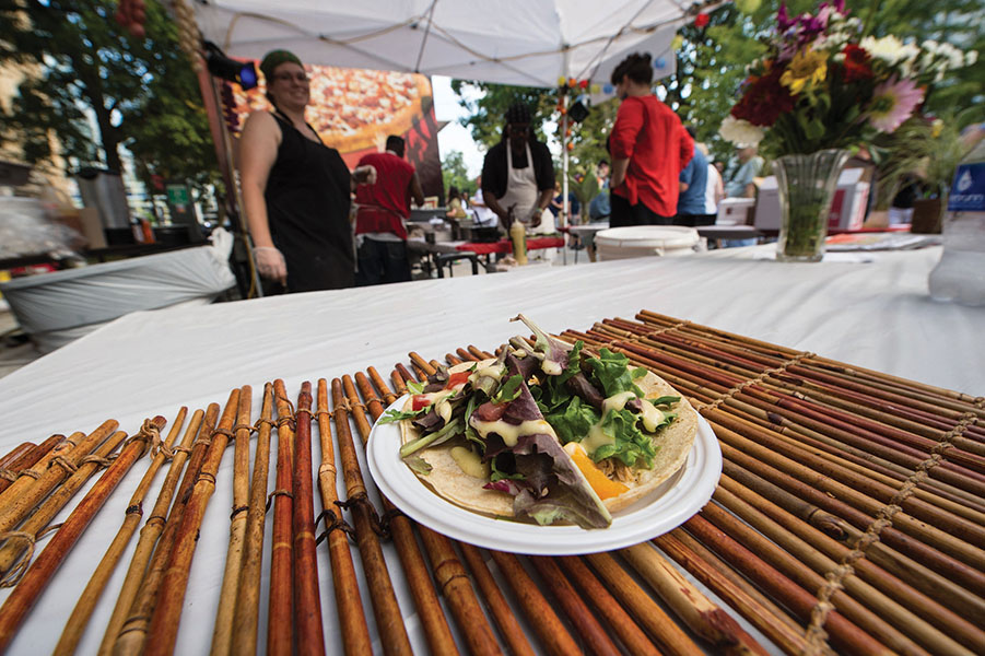 A vendor displays a dish at the 2015 Taste of Madison.
