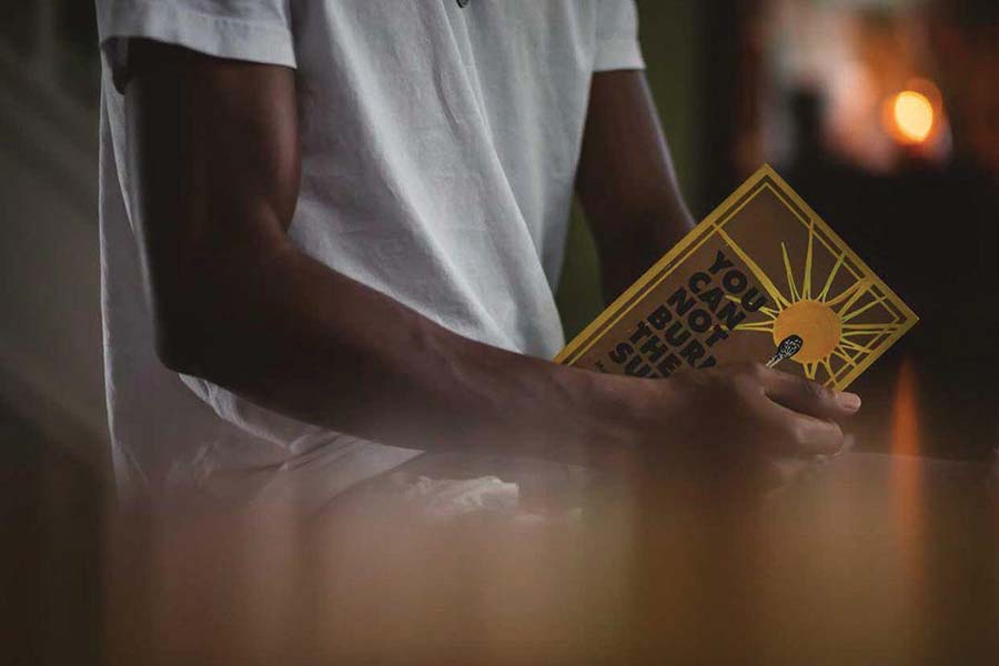 Matthew Charles holds his book “You Cannot Burn the Sun.”