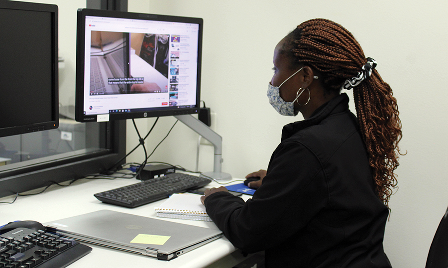 A volunteer works in the re-opened WolfPack Techies office at the Truax Campus.