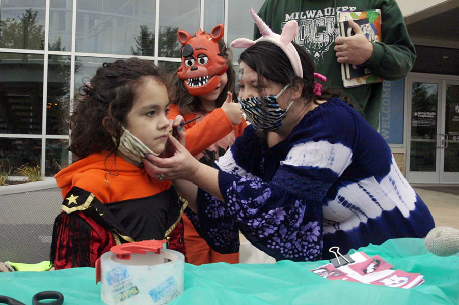 Kelli Kahl works the face painting booth at the Phi Theta Kappa event, “Spooktacular,” at Madison College’s Truax Campus.