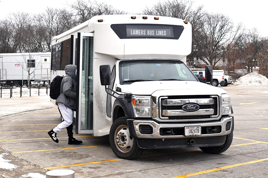 A Madison College student boards the campus-to-campus shuttle outside the main Truax Campus building.