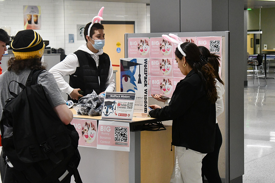 Students encourage others to participate in the WolfPack Wisdom Channel’s Bunny Bonanza event.