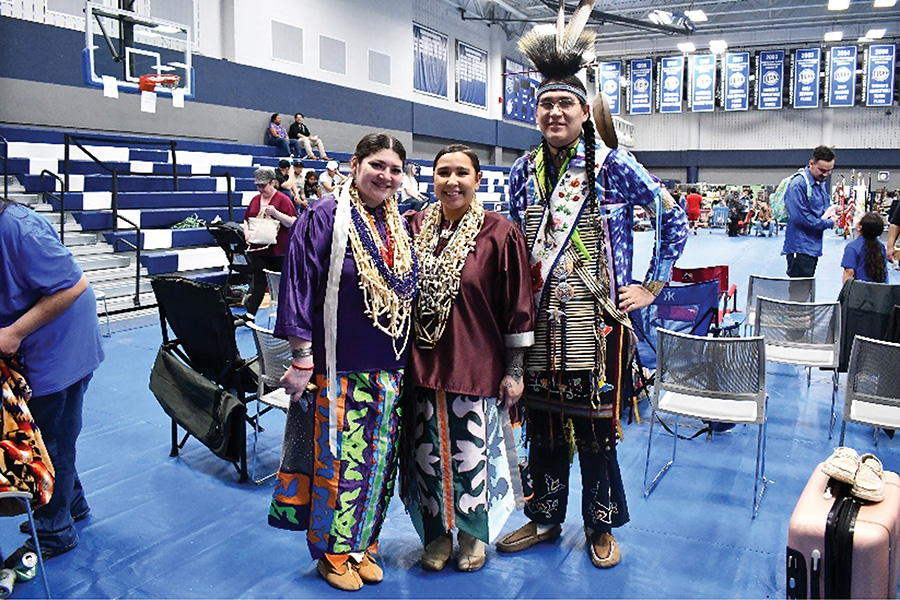 Penny from Menominee and a student at Madison College, join her mother (middle) and father (right) for a photo at the Madison College Powwow.