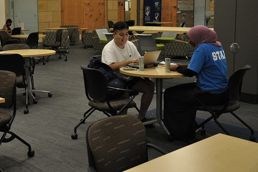 Students study in the open space outside the Intercultural Exchange on the first floor of the main Truax Campus building.