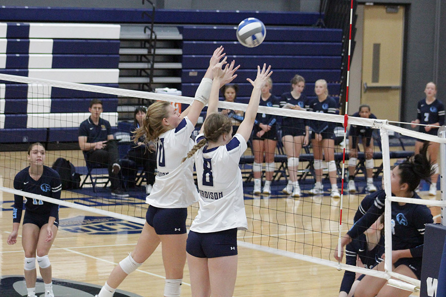 Madison College’s Gabby Hack (10) and Sophia Venne (8) attempt to block an attack during their team’s match against Rock Valley College on Sept. 7.