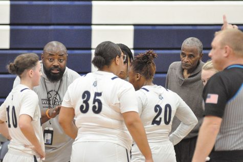 Madison College women’s basketball co-coaches James Adams, left, and Mike Mayfield, right, visit with their team during a timeout against Rockford University JV on Nov. 17.