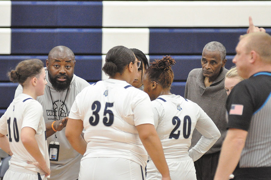 Madison+College+women%E2%80%99s+basketball+co-coaches+James+Adams%2C+left%2C+and+Mike+Mayfield%2C+right%2C+visit+with+their+team+during+a+timeout+against+Rockford+University+JV+on+Nov.+17.