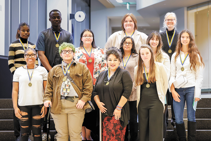 Newly inducted members of the Beta Beta Psi Chapter of the Phi Theta Kappa Honor Society gather for a photograph following the induction ceremony held in the Mitby Theater at the Truax Campus on Nov. 10