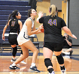 Madison College’s Nellie Kendall, center, looks to put up a shot against McHenry County College on Nov. 4 during her team’s home opener.