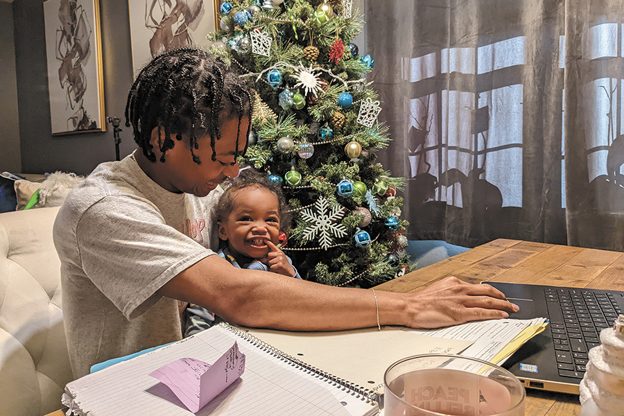 Madison College journalism student Darion Lanagan holds his daughter, ZaRayla.