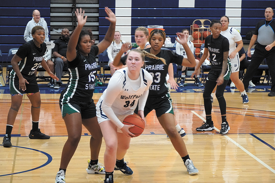 Madison College’s Cora Hansen (34) is trapped by the Prairie State College defense as she looks for a teammate to pass the ball to during a home game on Dec. 3.