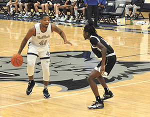 Telin Porter brings the ball up court for the Madison College mens basketball team on Dec. 3.