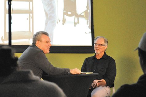 Madison College instructors Todd Bowie, left, and Larry Hansen visit during a special Writer’s Life Lecture Series presentation held at the Truax Campus in December.
