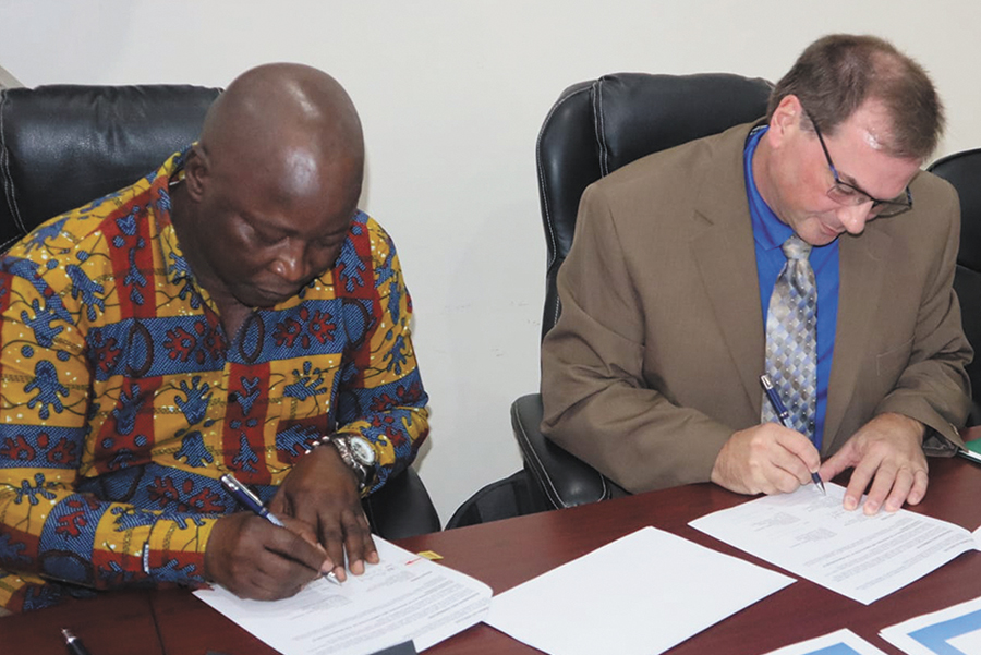 Dr. Geoffrey Bradshaw, the associate vice president of international education at Madison College, joins Acting Minister Madi Jacca at a signing ceremony marking the college’s partnership agreement with the Ministry of Higher Education, Research, Science and Technology in The Gambia in West Africa.