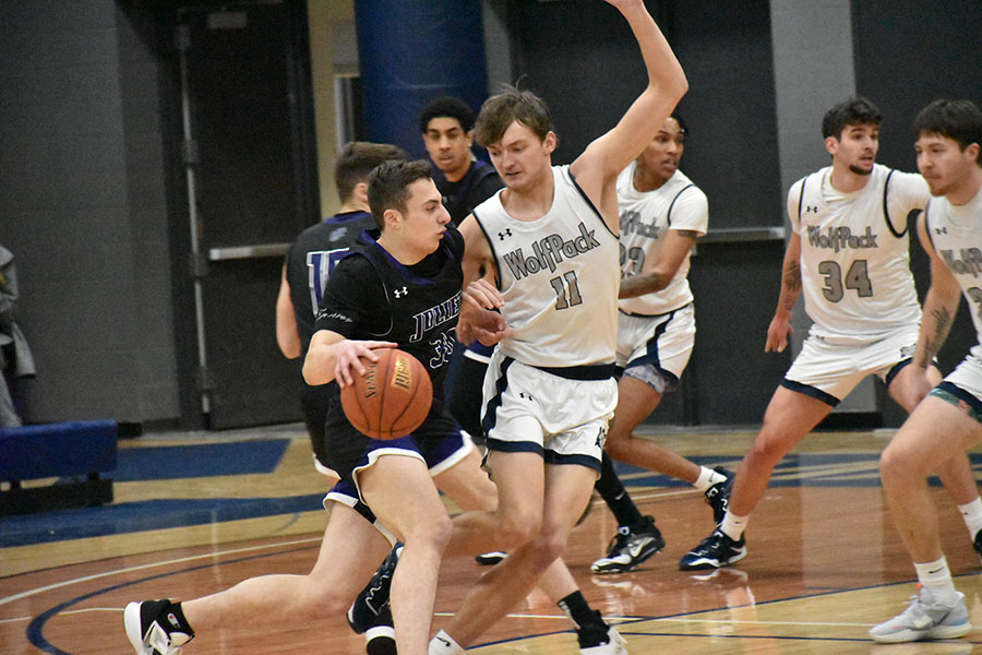 Madison Colleges Peter Gustafson tries to stop a driving opponent during a recent game.