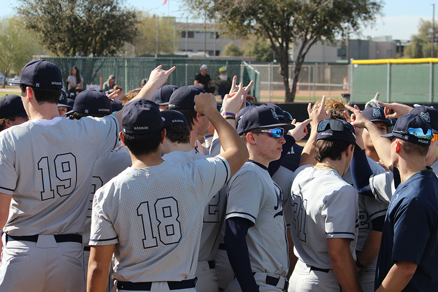 Members of the Madison College baseball team gather on the diamond before a game during their Arizona spring trip.