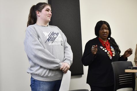 Hannah Fleming, left, and Katrina Willis help preside over the Delta Alpha Pi international honor society induction ceremony. (Jackson Crossen / Clarion)