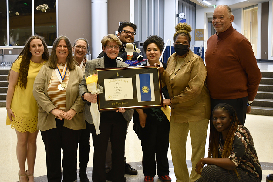 Phi Theta Kappa officers and Madison College President Dr. Jack Daniels, III, join retiring Provost Dr. Turina Bakken for a photo after presenting her with an honorary membership.