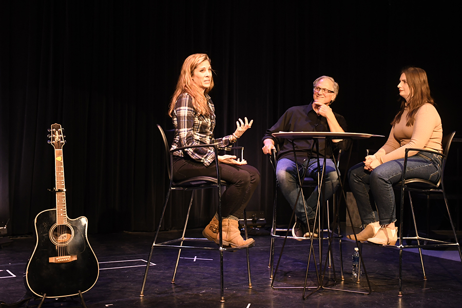 Musician Beth Kill visits with journalism program director David Hansen and student Lauren Taillon during a Writers Life Series presentation on Nov. 29.