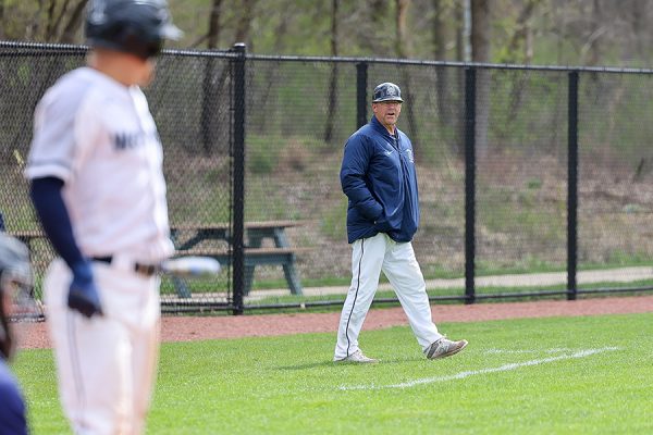 Madison College baseball coach Mike Davenport directs a batter during a game against Carl Sandburg College during the 2023 season. (Jim Garvey / Madison College Athletics)